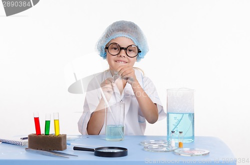 Image of Girl Chemist opens flask with reagent