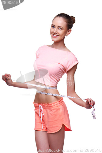 Image of Woman measuring her waist with a measuring tape