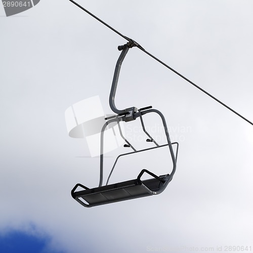 Image of Chair-lift and cloudy sky