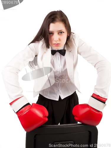 Image of Young angry businesswoman in boxing gloves