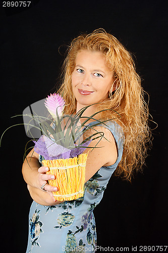 Image of Blond woman with plant