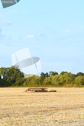 Image of Harrow among the stubble on harvested farmland