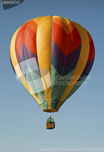 Image of Hot-air balloon floating in a blue sky