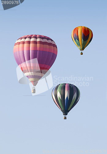 Image of Three Hot-Air Balloons Floating against a Blue Sky