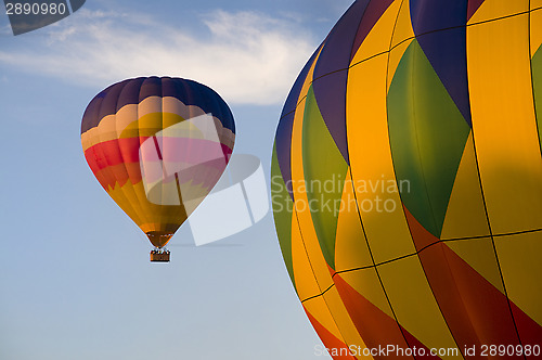 Image of Airborne hot-air balloon with another in foreground
