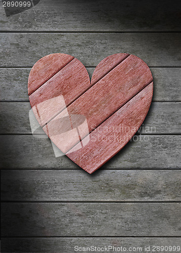 Image of Red wood heart on gray weathered wooden background