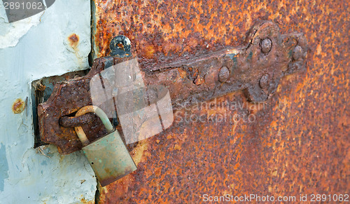 Image of Rusted Locked Solid Metal Door Hinge Padlock