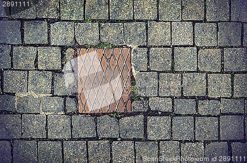 Image of Paving stones background with metal plate