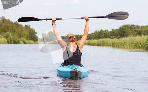 Image of Woman on a small river in rural landscape