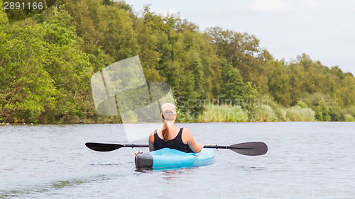 Image of Woman on a small river in rural landscape