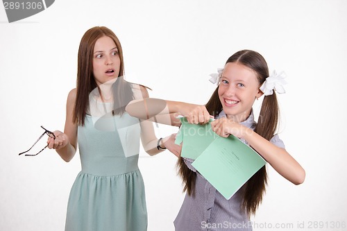 Image of Schoolgirl got a bad grade and tear notebook