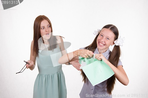 Image of Schoolgirl rips his notebook