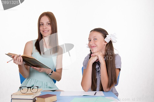 Image of Student and teacher sitting at the table