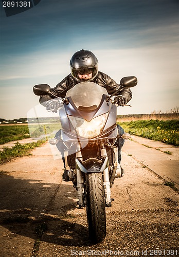 Image of Biker racing on the road