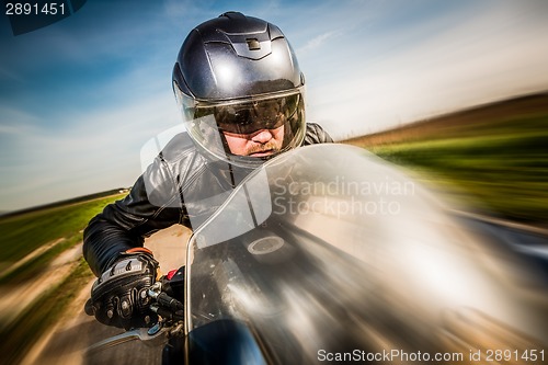 Image of Biker racing on the road