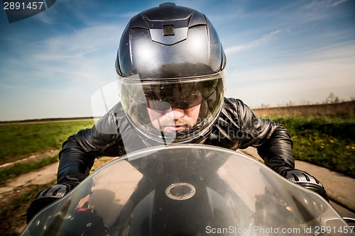 Image of Biker racing on the road