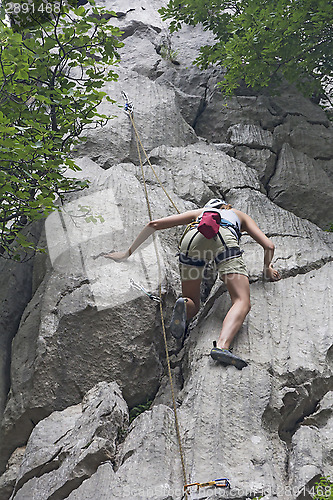 Image of Woman rock climbing