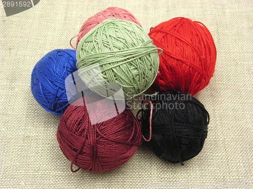 Image of A few balls of wool  on a beige background