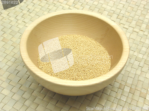 Image of Wooden bowl with amaranth on rattan underlay