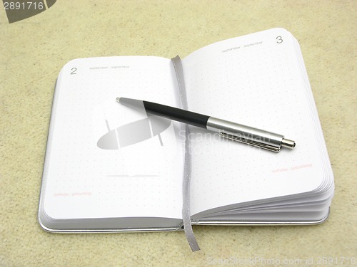 Image of To flip an appointment calendar open with ball pen