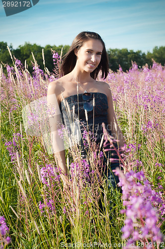 Image of Beautiful girl on the flowers field