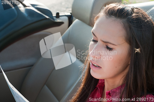 Image of Beautiful brunette woman is reading