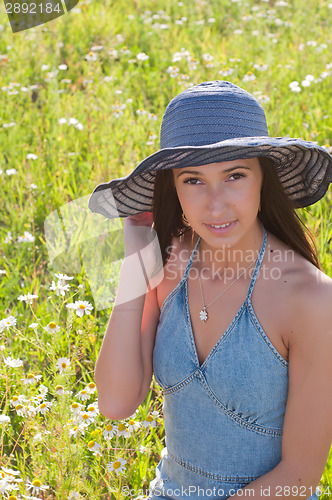 Image of Beautiful woman on the flowers field