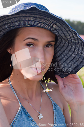 Image of Woman with chamomile in mouth