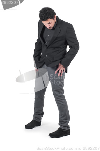 Image of Young cute guy holding hands in pockets