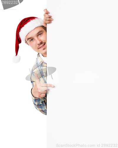 Image of Young man in Santa hat