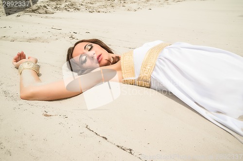 Image of Young pretty woman in greek tunic