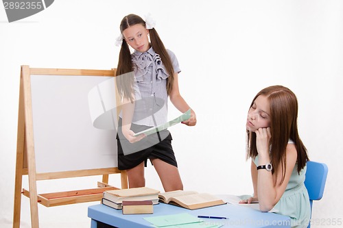 Image of Teacher at blackboard teacher saw that she fell asleep