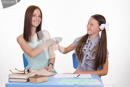 Image of Teacher and student shake hands with each other