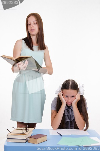 Image of Schoolgirl sitting on a boring lesson