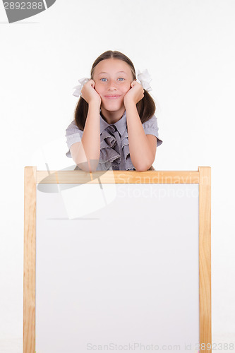 Image of Teen girl having fun is at the advertising stand