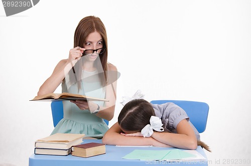 Image of The teacher saw sleeping student