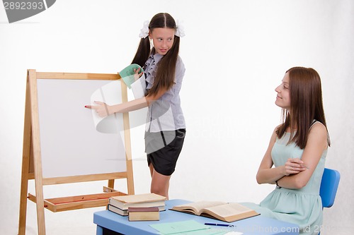 Image of The pupil answers at blackboard in classroom