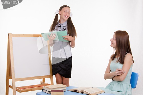 Image of The pupil answers lesson at blackboard in classroom