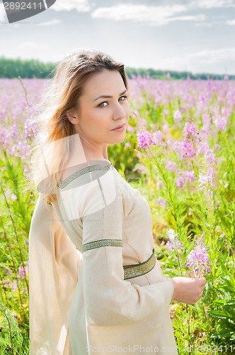 Image of Pretty sad girl on meadow