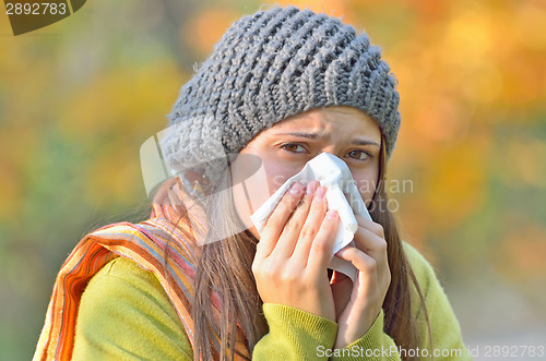 Image of girl blowing nose