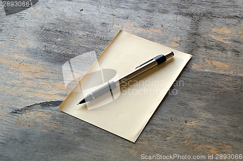 Image of pencil and paper on wood