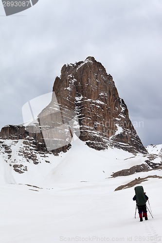 Image of Hikers at snowy cloudy mountains