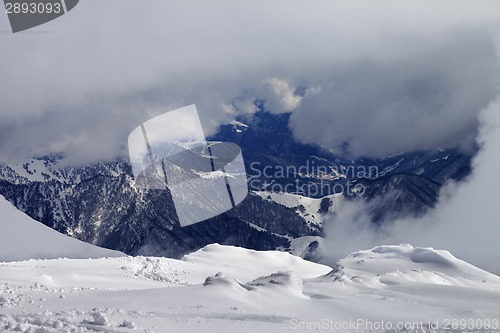 Image of Winter snowy mountains in clouds