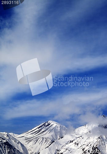 Image of Winter snowy mountains and sky with clouds at nice day