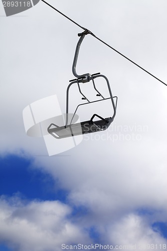 Image of Chair-lift and cloudy sky