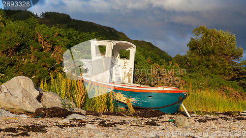 Image of Small shipwreck at a loch with stone beach