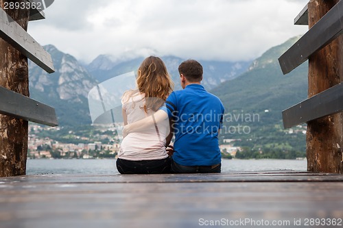 Image of Young couple on the pier looking on Como lake