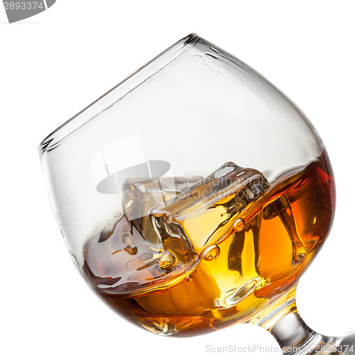 Image of Splash of whiskey with ice in glass isolated on white background