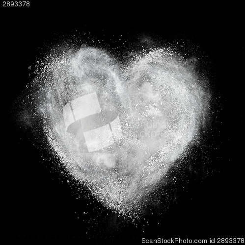 Image of heart made of white powder explosion isolated on black