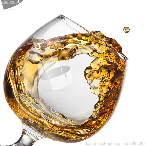 Image of Splash of cognac in glass isolated